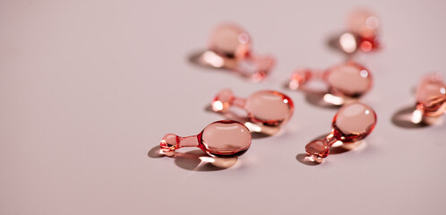 Skin care revitalising capsules for youthful skin, face serum, collagen Professional cosmetics. Face care, pink liquid-filled capsules. Beauty treatment 