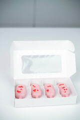 Heart-shaped treats in a box perfect for Valentine's Day celebration with love-themed decorations and a pastel color theme