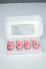 Heart-shaped treats in a box perfect for Valentine's Day celebration with love-themed decorations and a pastel color theme