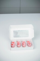 Heart-shaped treats in a box perfect for Valentine's Day celebration with love-themed decorations and a pastel color theme