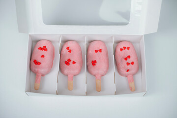 Heart-shaped treats in a box perfect for Valentine's Day celebration with love-themed decorations and a pastel color theme