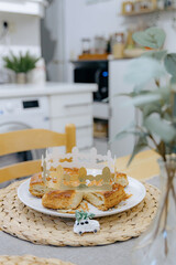 A cut royal galette with a golden crown on a table in the kitchen.