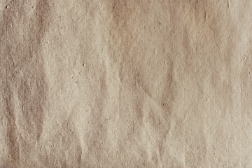 Close up of a beige paper texture with subtle wrinkles and imperfections