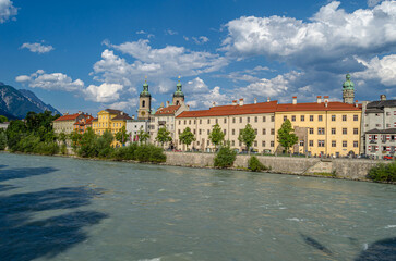 Fototapeta premium Buildings with colorful facades on the banks of the Inn River in Innsbruck, Austria