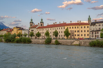Fototapeta premium Buildings with colorful facades on the banks of the Inn River in Innsbruck, Austria