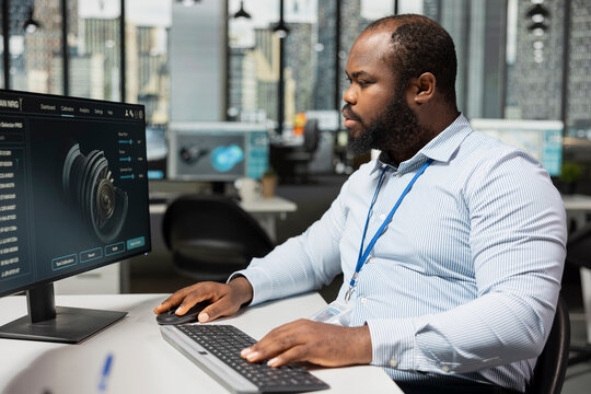 CAD technician uses PC program in office to upgrade turbine, boosting power output and reducing carbon footprint. RD department specialist reviews turbine data to optimize efficiency