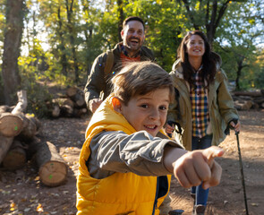 Hikers behind son looking at something he is pointing at