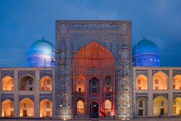 Illuminated Madrasah with Blue Domes at Dusk in Bukhara - Uzbekistan