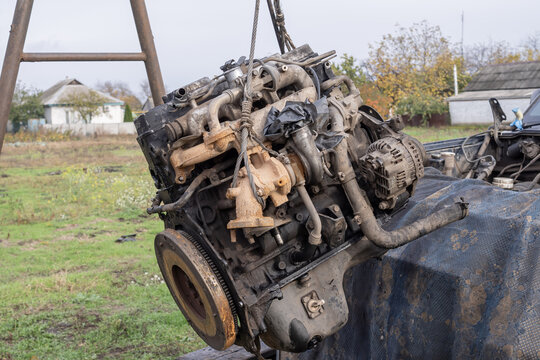 Macro view of used car engine showing oil stains, pulleys, and tubes. Ideal for concepts of repair, engineering, automotive industry, and mechanical work.