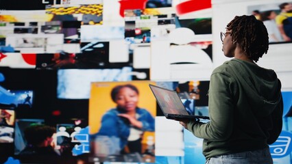 Smiling woman using laptop satisfied by access to video recommendations delivered instantly. Joyful...