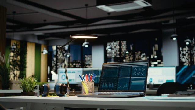 Luxurious modern office space with important reports on laptop, empty desk showcasing important data analytics and insight for management and business administration tasks. Forecasting.