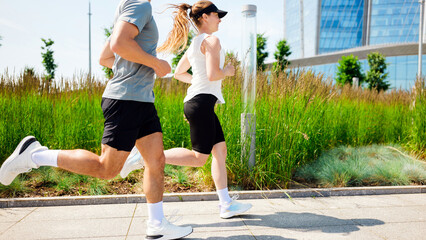 Jogging in a modern urban setting with green landscaping and sleek buildings