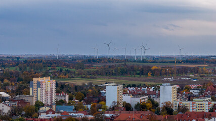 Obraz premium Polish town edge with apartments and wind turbines near Malbork