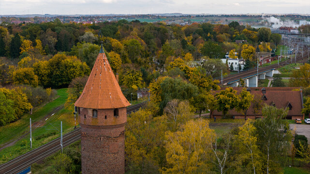 Aerial autumn view of red brick tower near Malbork railway lines