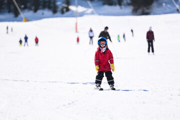 Child learning skiing during winter vacation