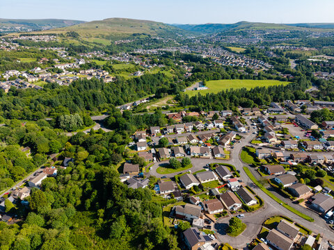 Summer landscape showing a residential housing estate in the green hills of Wales