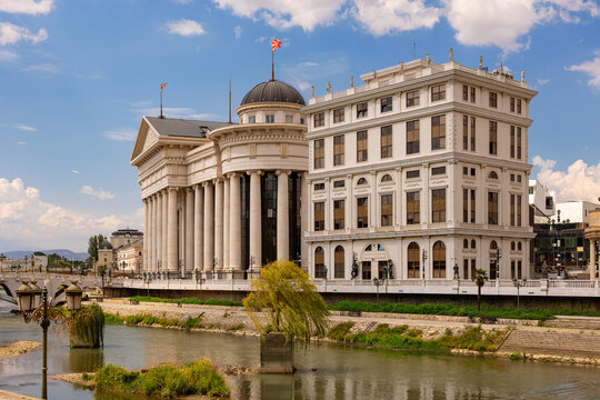 Scenic view of Archaeological Museum of Macedonia with elegant neoclassical columns and dome standing in Skopje by Vardar River on bright summer day