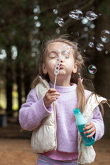 Child blowing bubbles outdoors in a fun playful scene