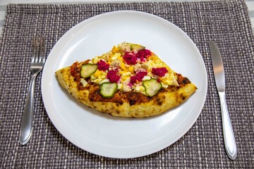 Exotic and original Brazilian pizza with two flavors, one with anchovies and the other with egg, horseradish, and cucumber pickles.