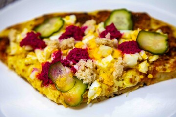 Exotic and original Brazilian pizza with two flavors, one with anchovies and the other with egg, horseradish, and cucumber pickles.