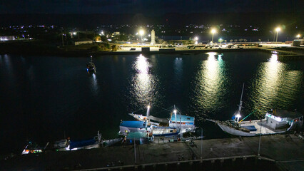 The atmosphere of Waingapu's Old Town to the Seaport seen from the air with a drone at night