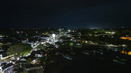 The atmosphere of Waingapu's Old Town to the Seaport seen from the air with a drone at night