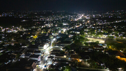 The atmosphere of Waingapu's Old Town to the Seaport seen from the air with a drone at night