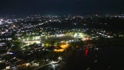 The atmosphere of Waingapu's Old Town to the Seaport seen from the air with a drone at night