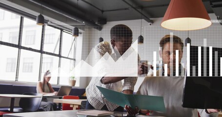 Leaning Black male and white male reviewing documents at modern office, with folder and monitor