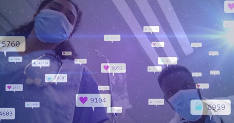 Peering masked healthcare professionals in scrubs in clinic room, with floating social media icons