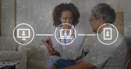 Explaining consultant guiding client in modern lounge, with tablet and network icons