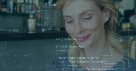 Smiling woman looking down at cafe counter, with programming code overlay, copy space