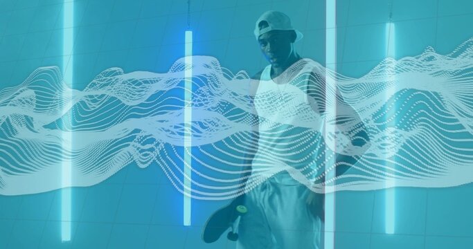 Posing man wearing backward cap and tank top in studio, with skateboard, neon tubes, waveform - Powered by Adobe