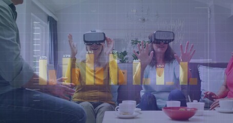 Using VR headsets friends raising hands on sofa in living room, with coffee table cups