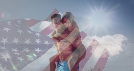 Couple giving piggyback ride at shoreline, with swim shorts, bikini, sunglasses, US flag overlay