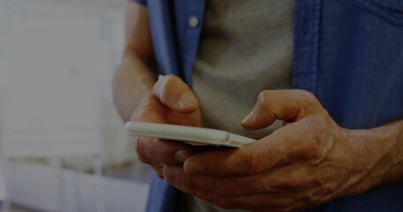 Man's hands scrolling smartphone in bright cafe near window, with white smartphone