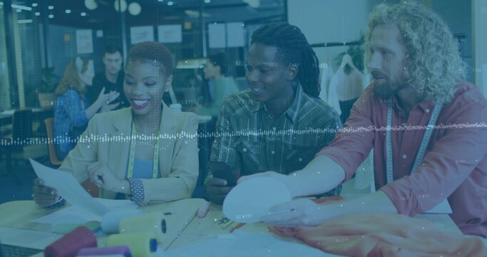 Collaborating design team arranging fabric swatches in design studio with measuring tape and sphere - Powered by Adobe