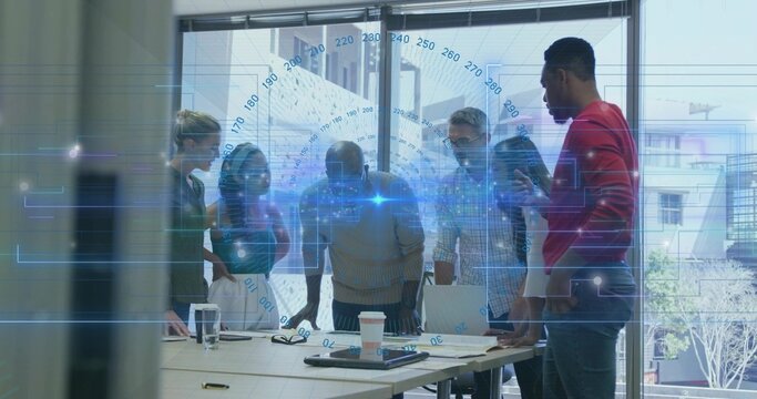 Collaborating project team pointing at laptops in conference room, with digital data overlay