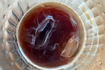 Ice cubes in a glass ashtray. Close-up.