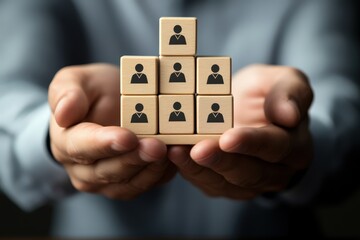 Teamwork on the Horizon: A pair of hands tenderly cradles a miniature structure representing teamwork and human resources, highlighting collaborative efforts and organizational synergy.