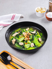 Indonesian Vegetable Soup with Chicken and Green Mustard in Black Bowl – Healthy Asian Cuisine Food Photography