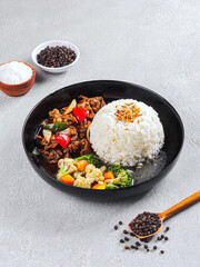 Indonesian Beef Black Pepper with Rice and Vegetables on Black Plate – Asian Cuisine Food Photography
