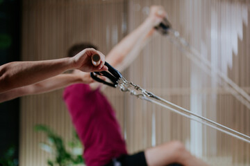 Engaging in a challenging workout on reformer pilates machines at a fitness studio during an...