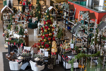 Holiday decoration display in a festive retail store showcasing trees, ornaments, and gift items