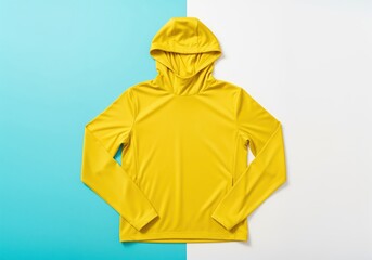Vibrant yellow technical sports hoodie with hood, flat lay on a split color background.