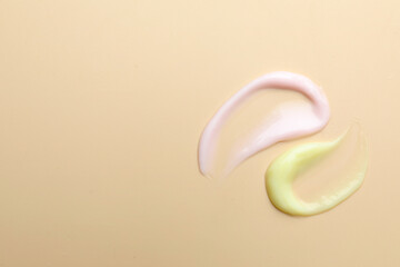 Samples of different cosmetic products on beige background, flat lay. Space for text