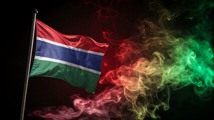 The gambia flag waving in the dark with colorful smoke effect