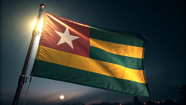 Togo flag waving against the night sky with a bright moon - Powered by Adobe