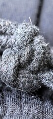 Knotted dark gray fabric macro shot