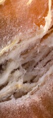 Torn bread interior reveals airy crumb structure